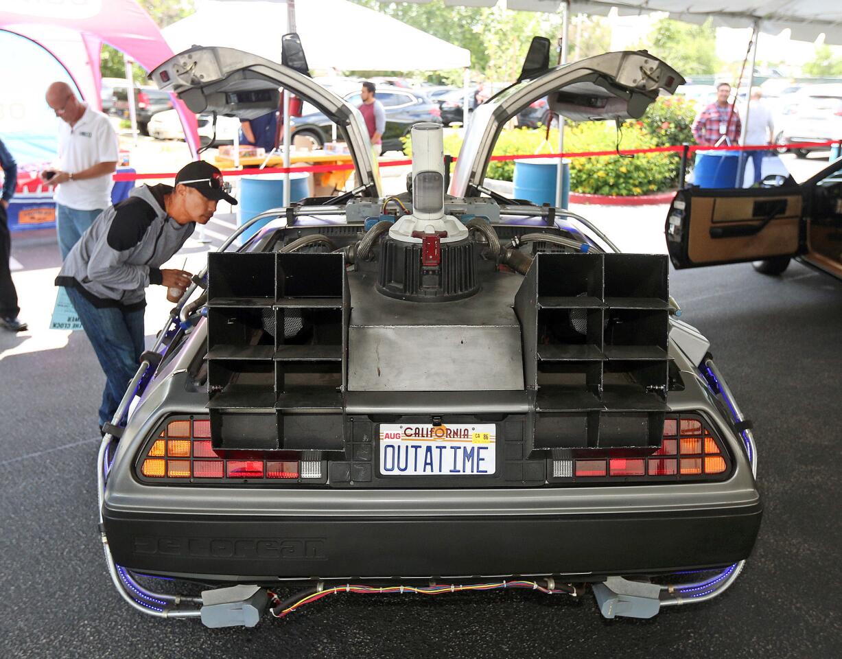 Julius Garcia gets close to the Delorean from Back To The Future at Walmart in Burbank on Monday, May 6, 2019. The cars, which were famous from the Ghostbusters, Jurassic Park, Back To the Future movies and Knight Rider television show, were all in a Walmart Super Bowl ad, and on display in the parking lot. Organizers for Walmart are touring with the cars, which are on loan from collectors from around the nation, for the next six weeks.