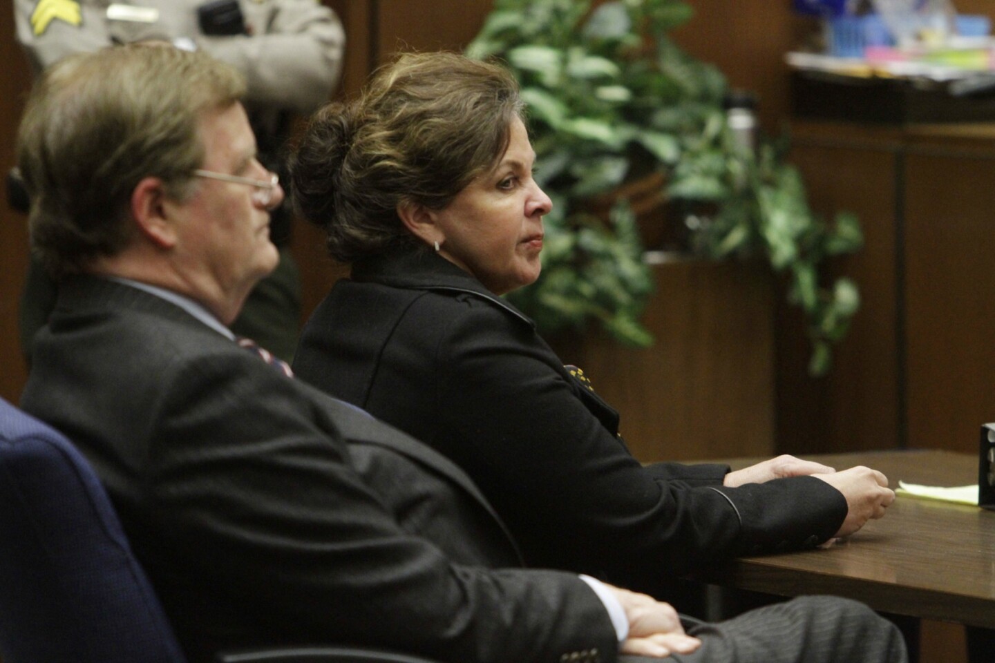 Angela Spaccia, right, Bell's former second in command, sits in a a downtown Los Angeles courtroom beside her attorney, Harland Braun, the day a jury reached verdicts in her case.