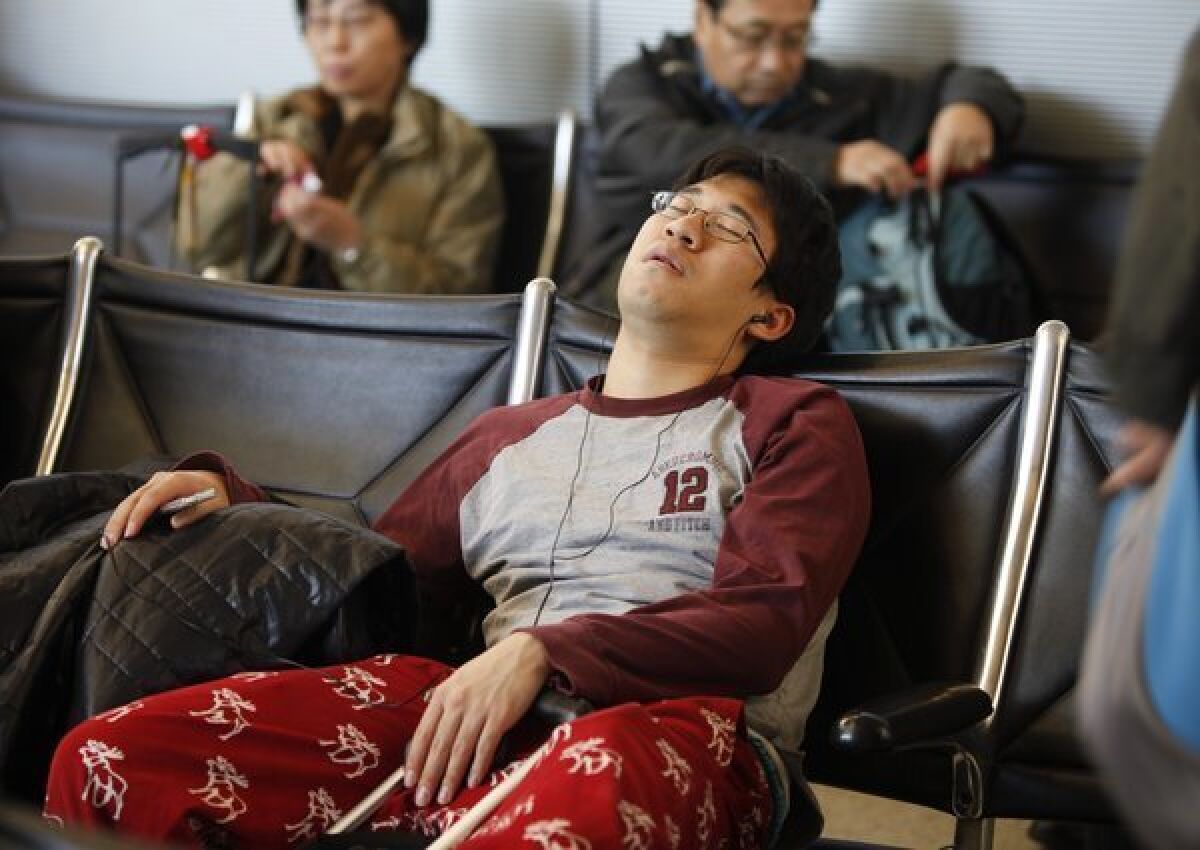 The number of people traveling over the holidays -- such as this man at LAX did last year -- is expected to break records in California and Southern California, according to the Auto Club of Southern California.