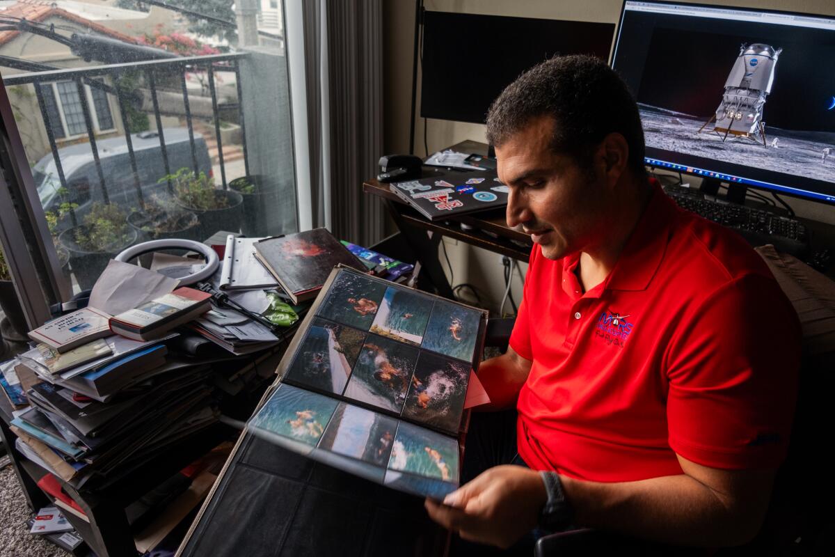 Loay Elbasyouni looks through a family photo album. 