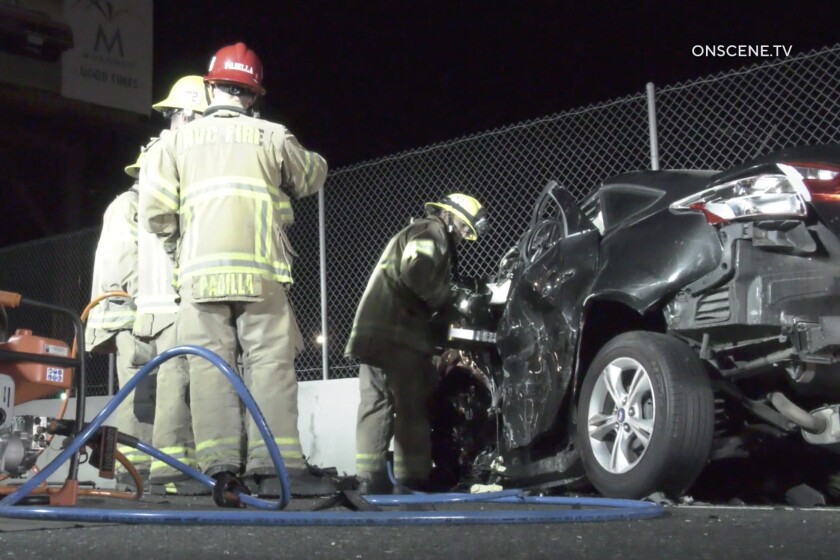 Firefighter at the scene of a two car head-on crash on the 215 Freeway early Tuesday morning, March 15, 2022, near Center Street in the Highgrove area of Riverside.