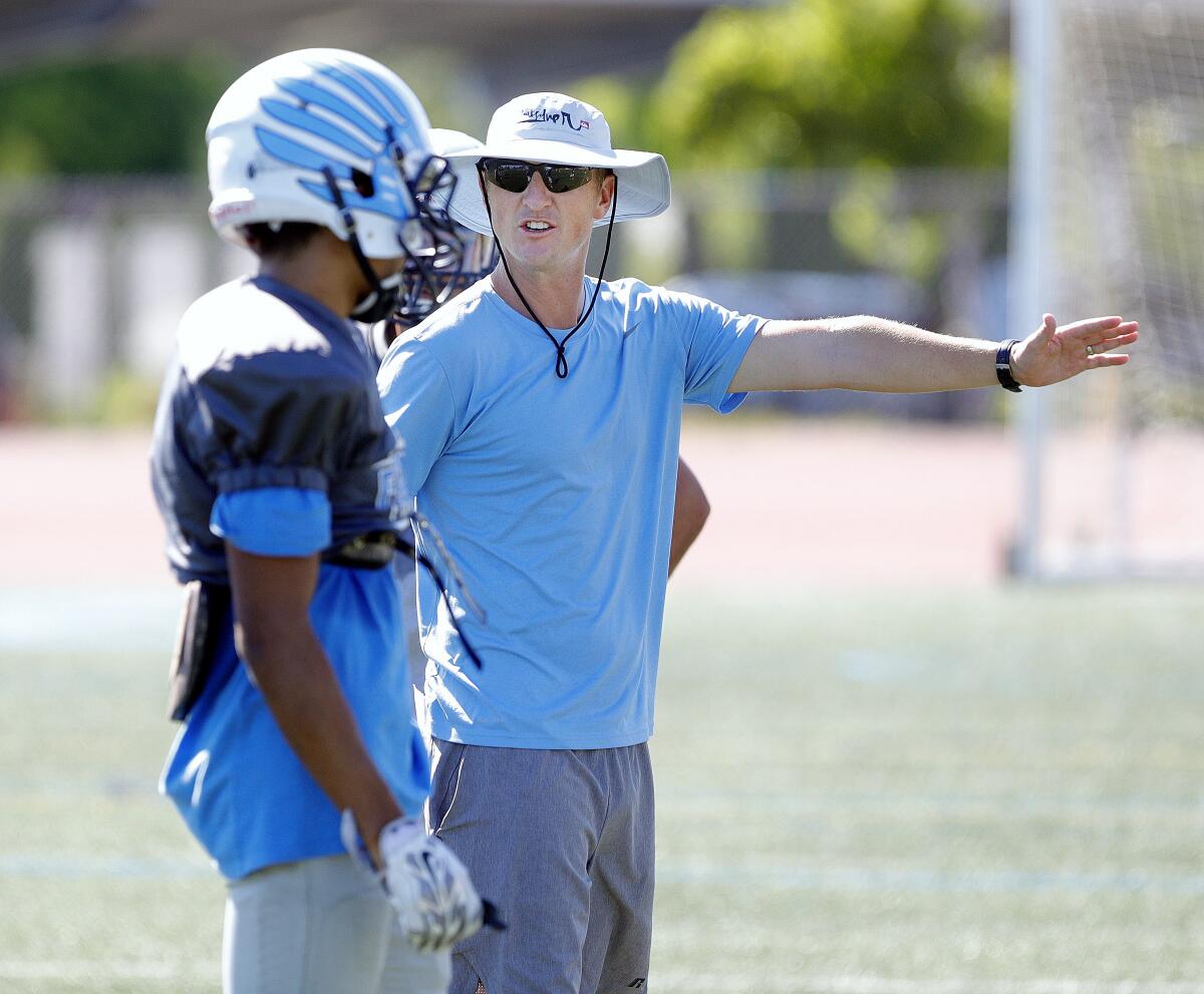 Crescenta Valley High first-year football coach Hudson Gossard talks with a player during a recent practice.