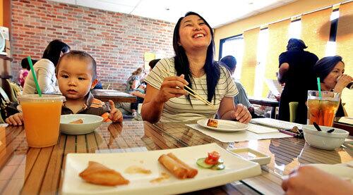 Katie Mac and her son Kyle Fung, 21-months-old, have lunch at Green Zone, which specializes in fine organic cuisine, in San Gabriel.