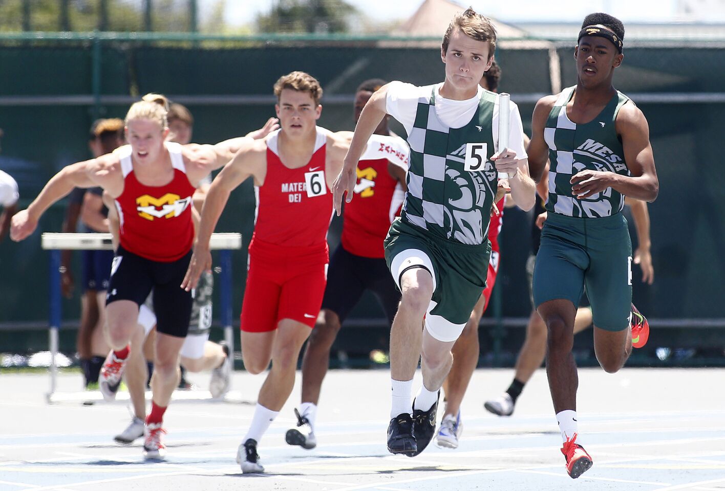 Murrieta Mesa's Ryan Wade takes the baton from teammate Shawn Williams to anchor their victory in the Divison 2 boys' 4x100-meter relay during the CIF Southern Section finals at Cerritos College.