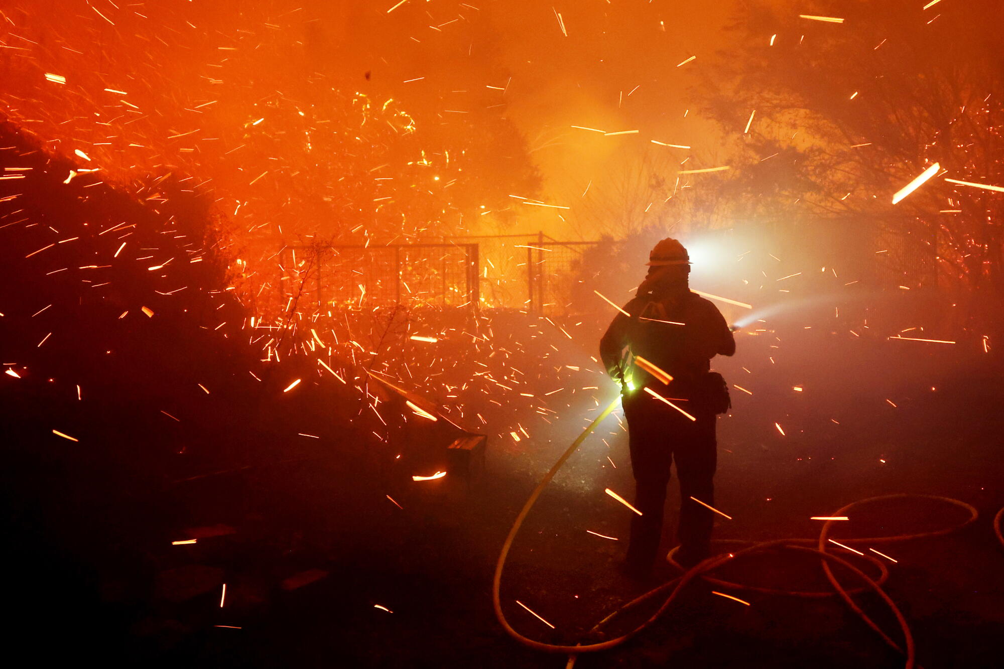 Archive: firefighter during the 2024 Franklin Fire in Malibu Archive image of a firefighter working in smoke and embers during the 2024 Franklin Fire