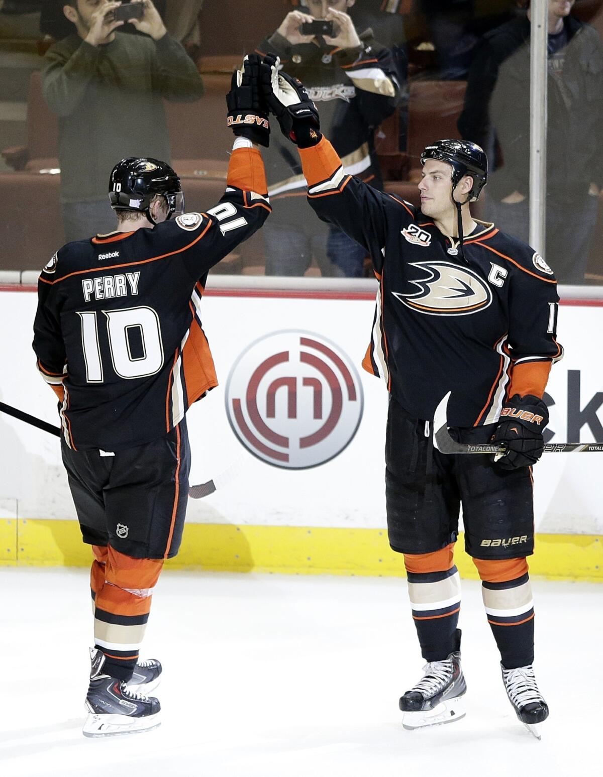 Ducks forwards Corey Perry, left, and Ryan Getzlaf celebrate a 6-0 victory over the New York Rangers on Oct. 10. Ducks Coach Bruce Boudreau is confident the team's power play will improve as the season continues.