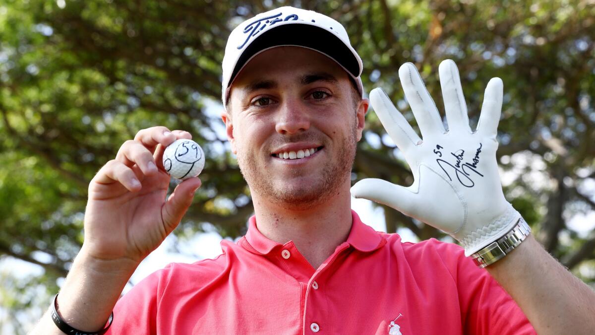 Justin Thomas celebrates after shooting a 59 during the first round of the Sony Open Waialae Country Club on Thursday.