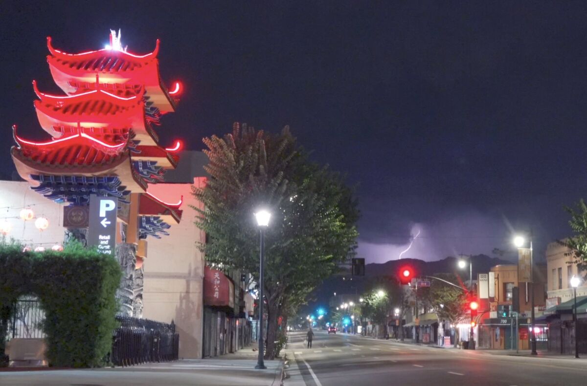 Thunder and lightning filling the sky in the Chinatown area of downtown Los Angeles on Thursday evening.