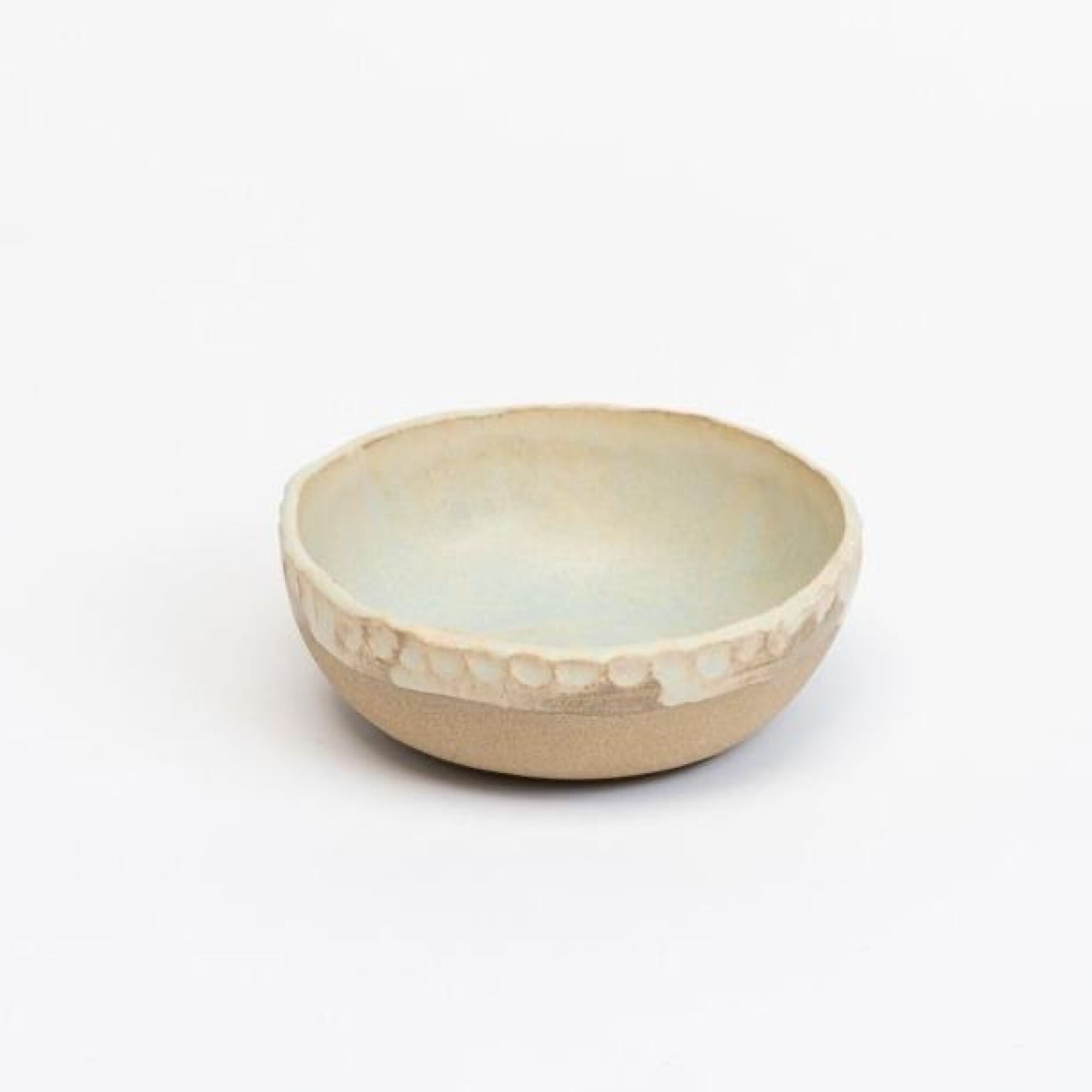 A ceramic bowl with fingerprints indented around its rim