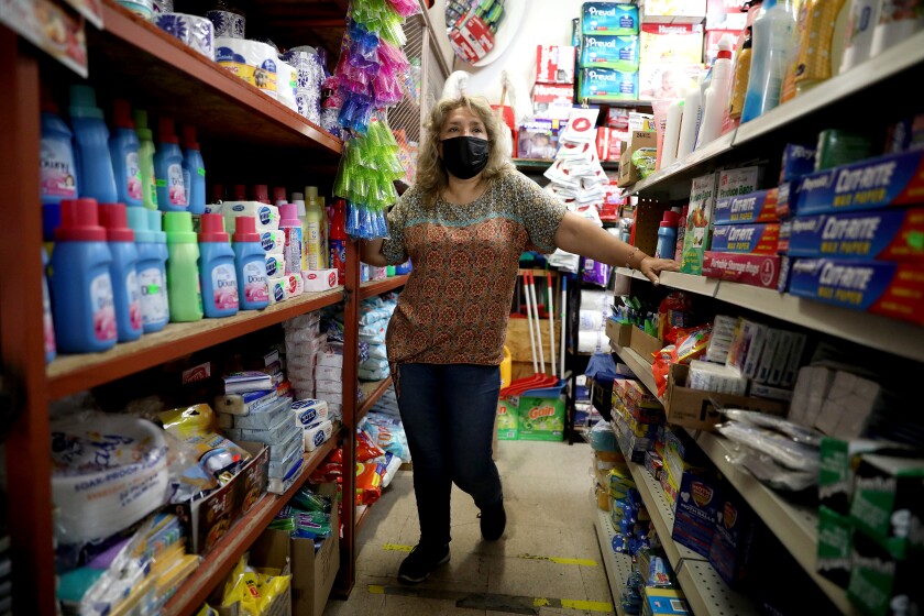 Gladys Colchado stands inside her Glady's 98¢ and Up store in South Los Angeles.