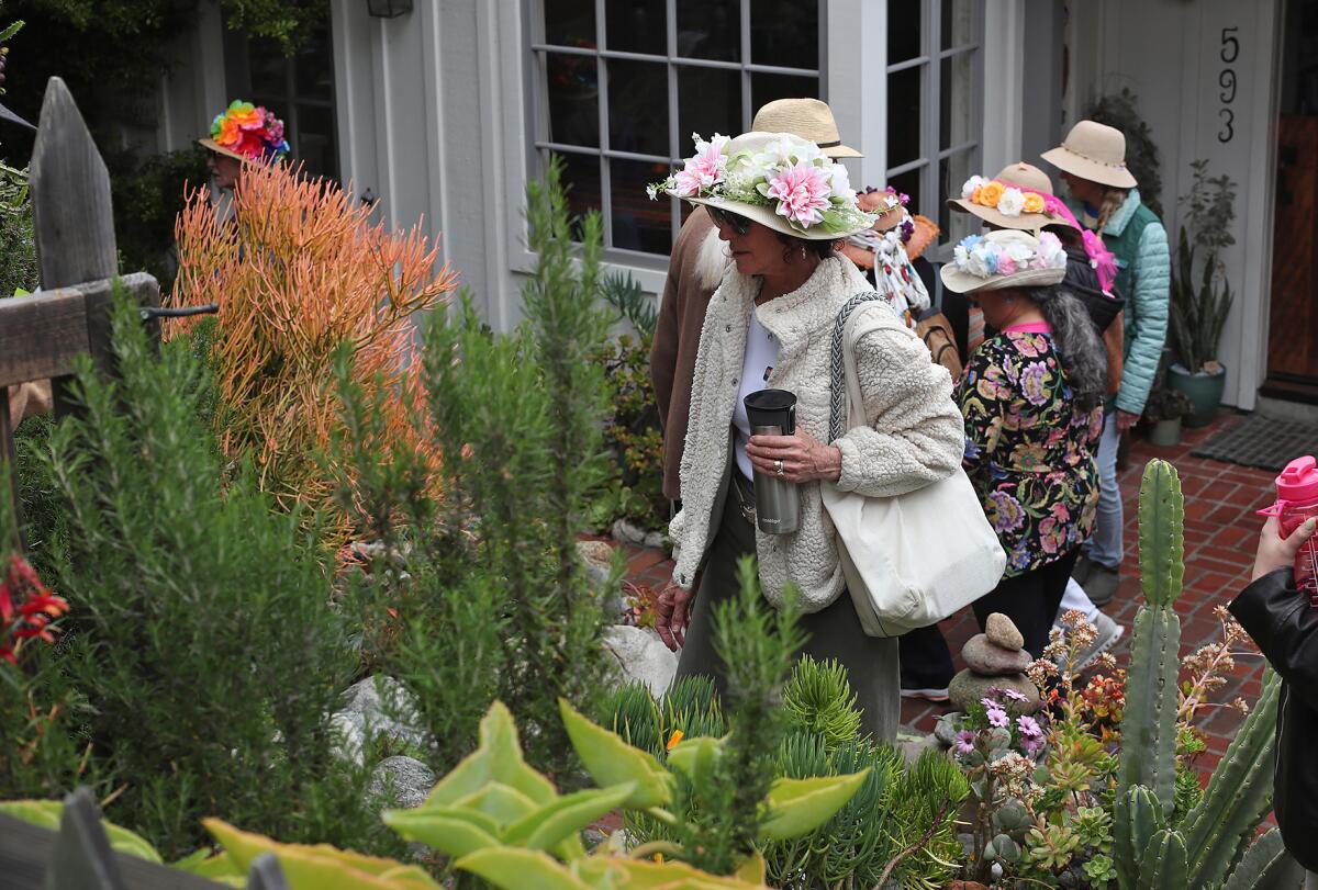 Guests walk through the yard of the "Frog Hallow" home during the Laguna Beach Garden Club's gate and garden tour.