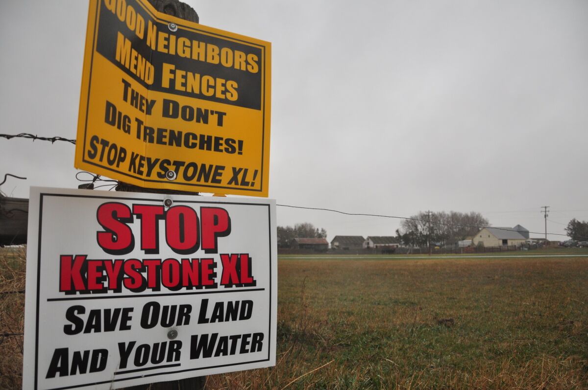 Signs are attached to a fence on the property of Jim Tarnick, a Nebraska farmer opposed to the Keystone XL pipeline project.