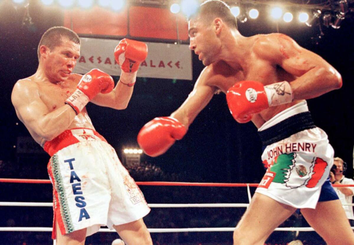 Oscar de la Hoya throws a punch against Julio Cesar Chavez