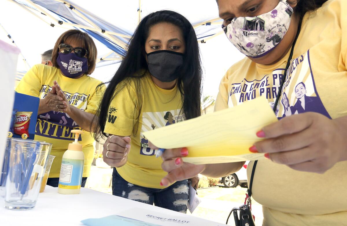 Zoila Carolina Toma, center, a longtime organizer with Child Care Providers United.