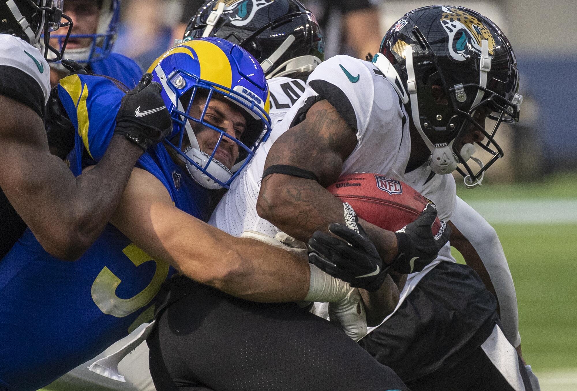 Rams linebacker Christian Rozeboom stops Jacksonville Jaguars wide receiver Jaydon Mickens in first half.