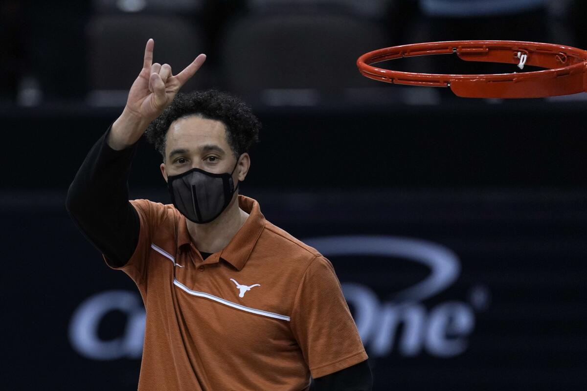 Texas coach Shaka Smart signals to the crowd after the Longhorns won the Big 12 tournament title March 13, 2021. 