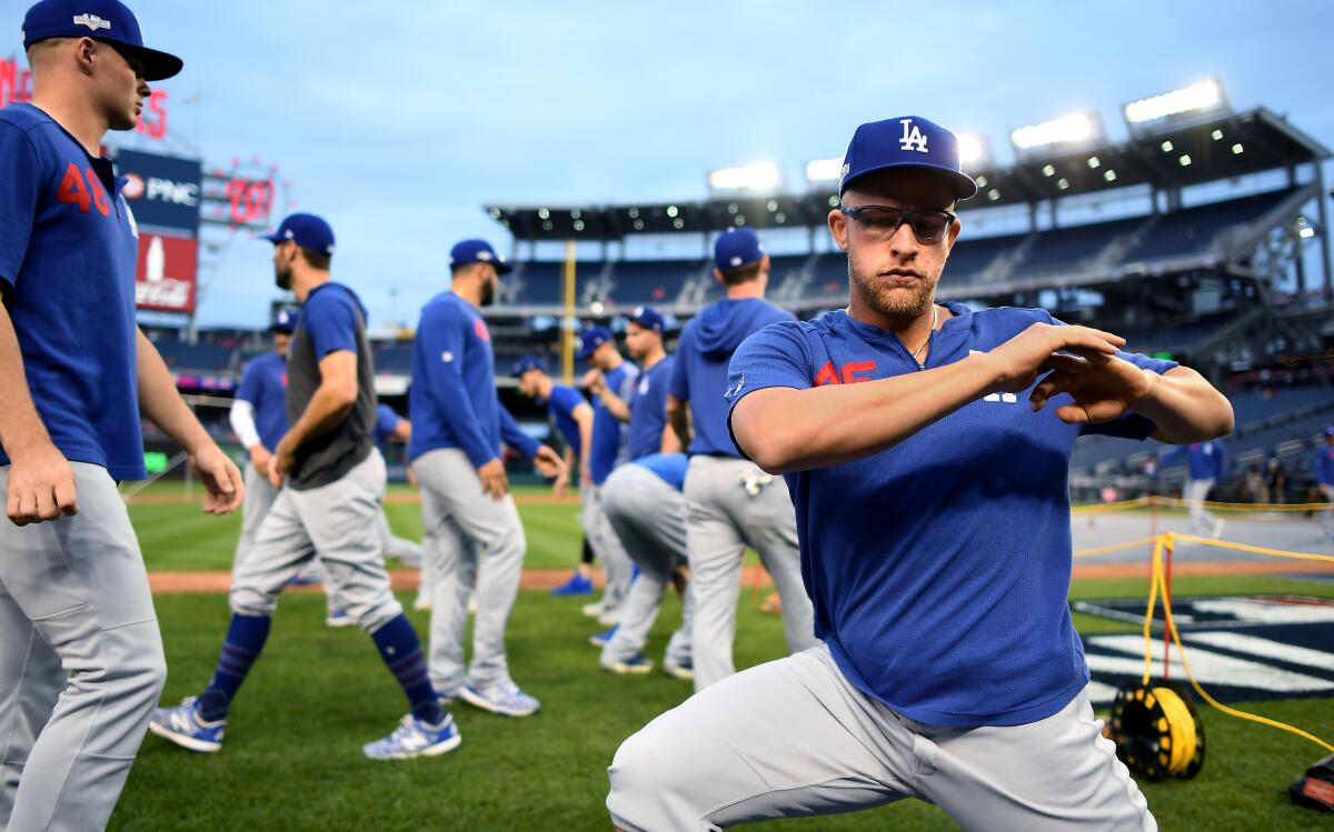 Dodgers' Matt Beaty stretches before Game 3 against the Washington Nationals on Sunday.