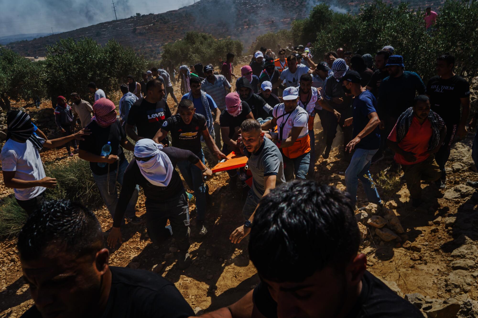 Protester shot by Israeli soldiers during a protest against a West Bank Jewish settlement is carried to safety
