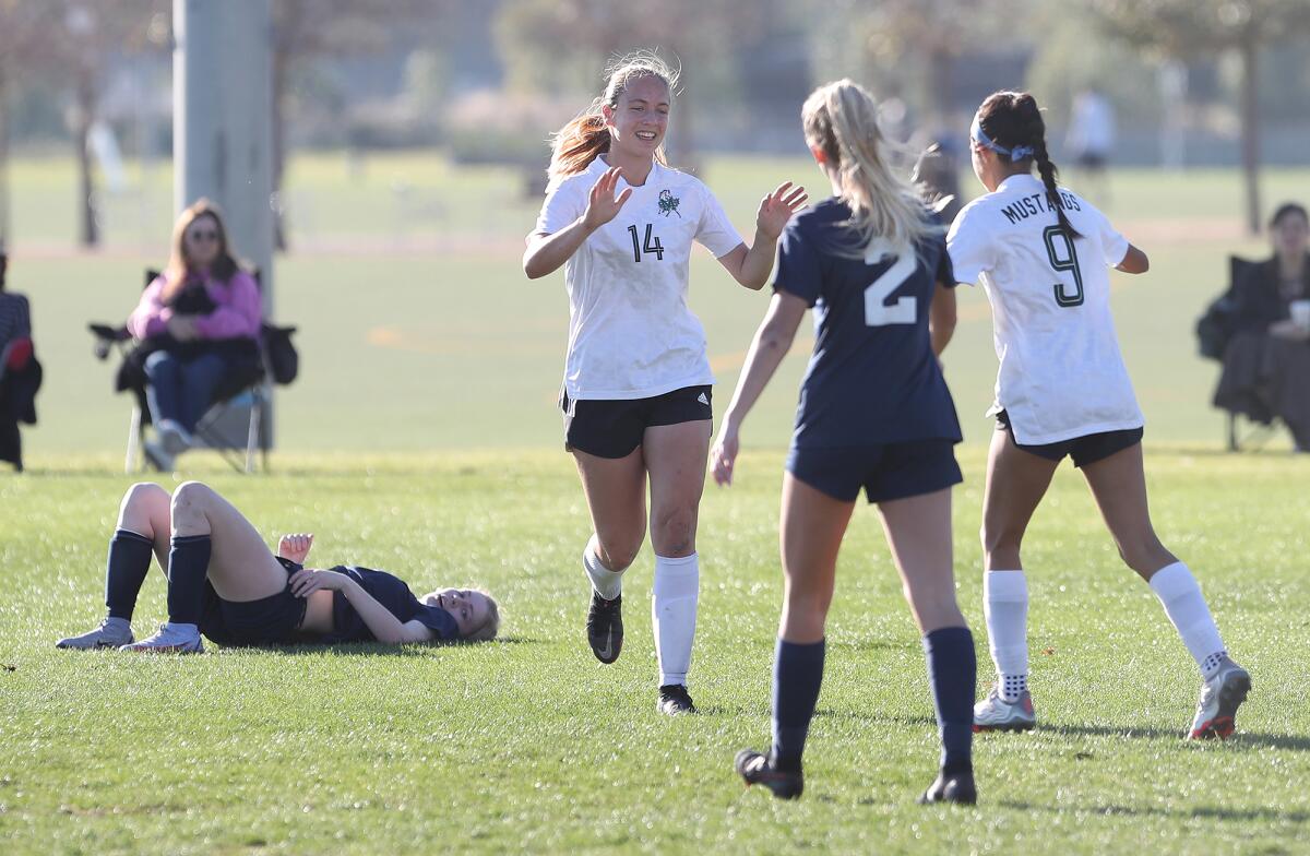 Costa Mesa's Kyra Kirsch (14) celebrates a goal with teammate Bryanna Elias (9) against Calvary Chapel on Thursday.