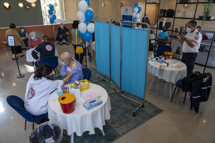 A man receives his fourth dose of the coronavirus vaccine in a private nursing home in Petah Tikva, Israel, Tuesday, Jan. 4, 2022. Even in relatively small, wealthy Israel, an early global leader against the coronavirus pandemic, the omicron variant is outpacing the government's ability to make and execute clear pandemic public policy. What once was a straightforward regimen of vaccines, testing, contact tracing and distancing for the nation of 9.3 million has splintered into a zigzag of rules that seem to change every few days. (AP Photo/Ariel Schalit)