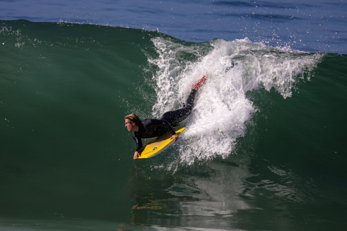 Dean Pistone, 16, rides high along the beach near Balboa Pier in Newport Beach on Saturday.