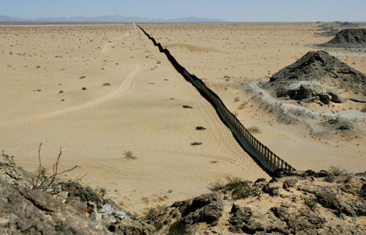 A border fence east of San Luis, Ariz., separates U.S. territory, left, and Mexico.
