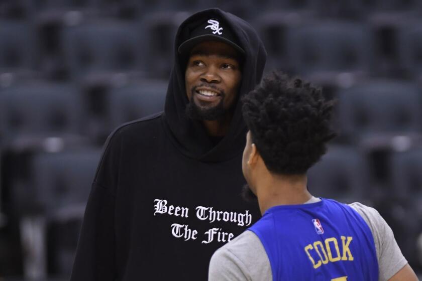 Golden State Warriors Kevin Durant, left, talks with teammate Stephen Curry during basketball practice at the NBA Finals in Toronto, Saturday, June 1, 2019. (Nathan Denette/The Canadian Press via AP)