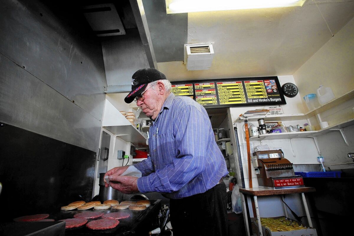 Bill Elwell, 87, plops patties onto the old flattop grill at his hamburger stand, Bill & Hiroko's Burgers, on Oxnard Street where Van Nuys meets Sherman Oaks. He crankily says he doesn't want any more customers, but they just keep showing up anyway.