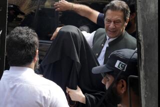 FILE - Pakistan's former Prime Minister Imran Khan, right, with his wife Bushra Bibi, center, arrive to appear in a court in Lahore, Pakistan, on June 26, 2023. A Pakistani court on Saturday, Feb. 3, 2024 convicted and sentenced imprisoned former Prime Minister Imran Khan and his wife Bushra Bibi to five years in prison each on a charge that their 2018 marriage violated the legal requirement that a woman wait three months before remarriage, officials and a defense lawyer said. (AP Photo/K.M. Chaudary, File)