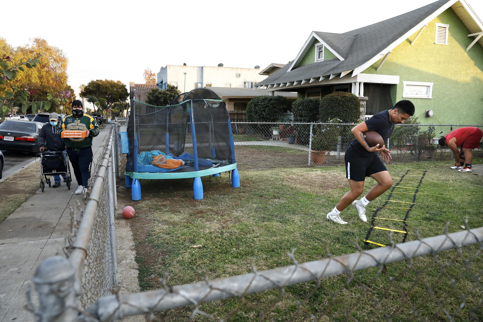 Roosevelt High football players Damian Avalos and Benjamin Reyes, far right, do a remote team workout 