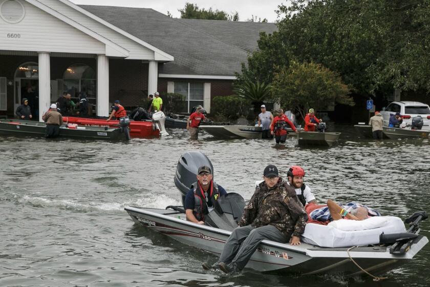 PORT ARTHUR, TEXAS -- WEDNESDAY, AUGUST 30, 2017: Search and rescue volunteers rescue patients from the Cypress Glen nursing home engulf in floodwater in Port Arthur, Texas, on Aug. 30, 2017. (Marcus Yam / Los Angeles Times)