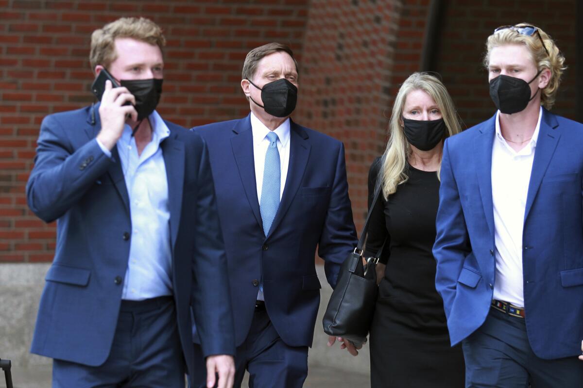 Four people leave the John Joseph Moakley Federal Courthouse.