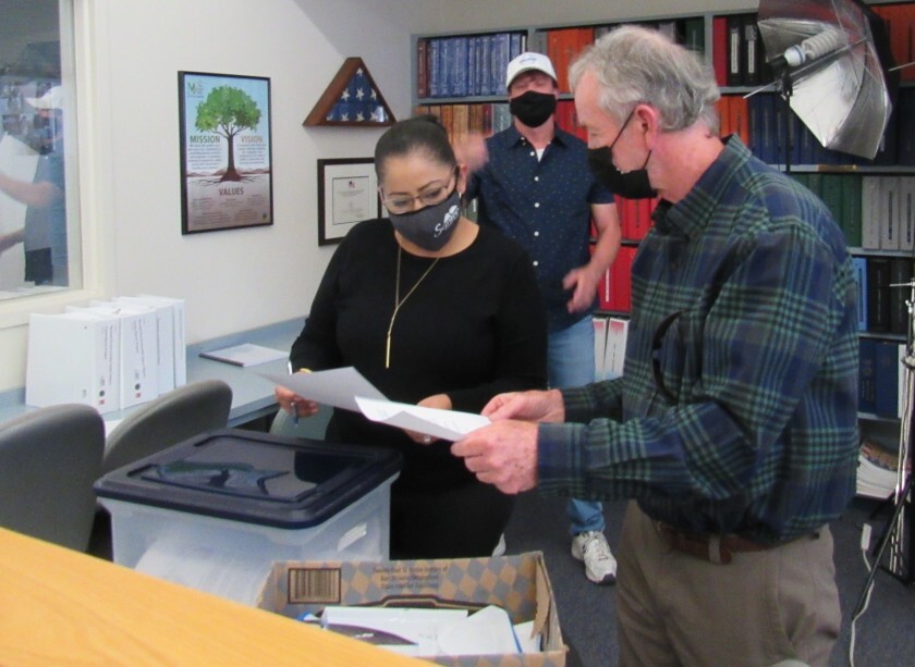 Santee City Clerk Annette Ortiz (left) looked over paperwork with Preserve Wild Santee spokesman Van Collinsworth.