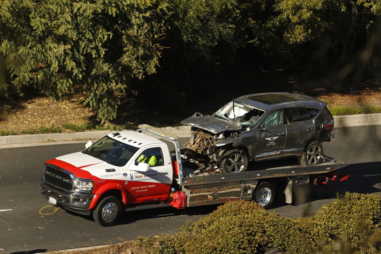 A tow truck transports Tiger Woods' SUV
