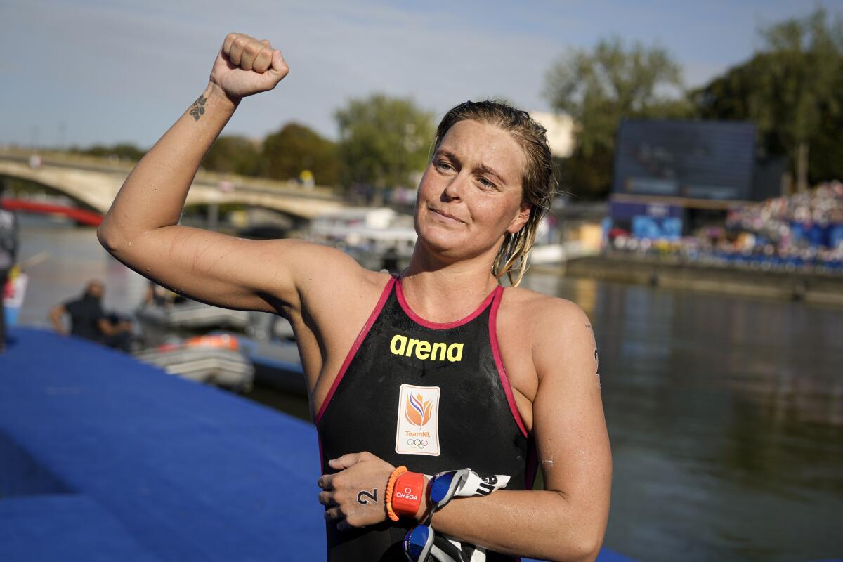 Sharon van Rouwendaal raises a fist at the Paris Olympics.