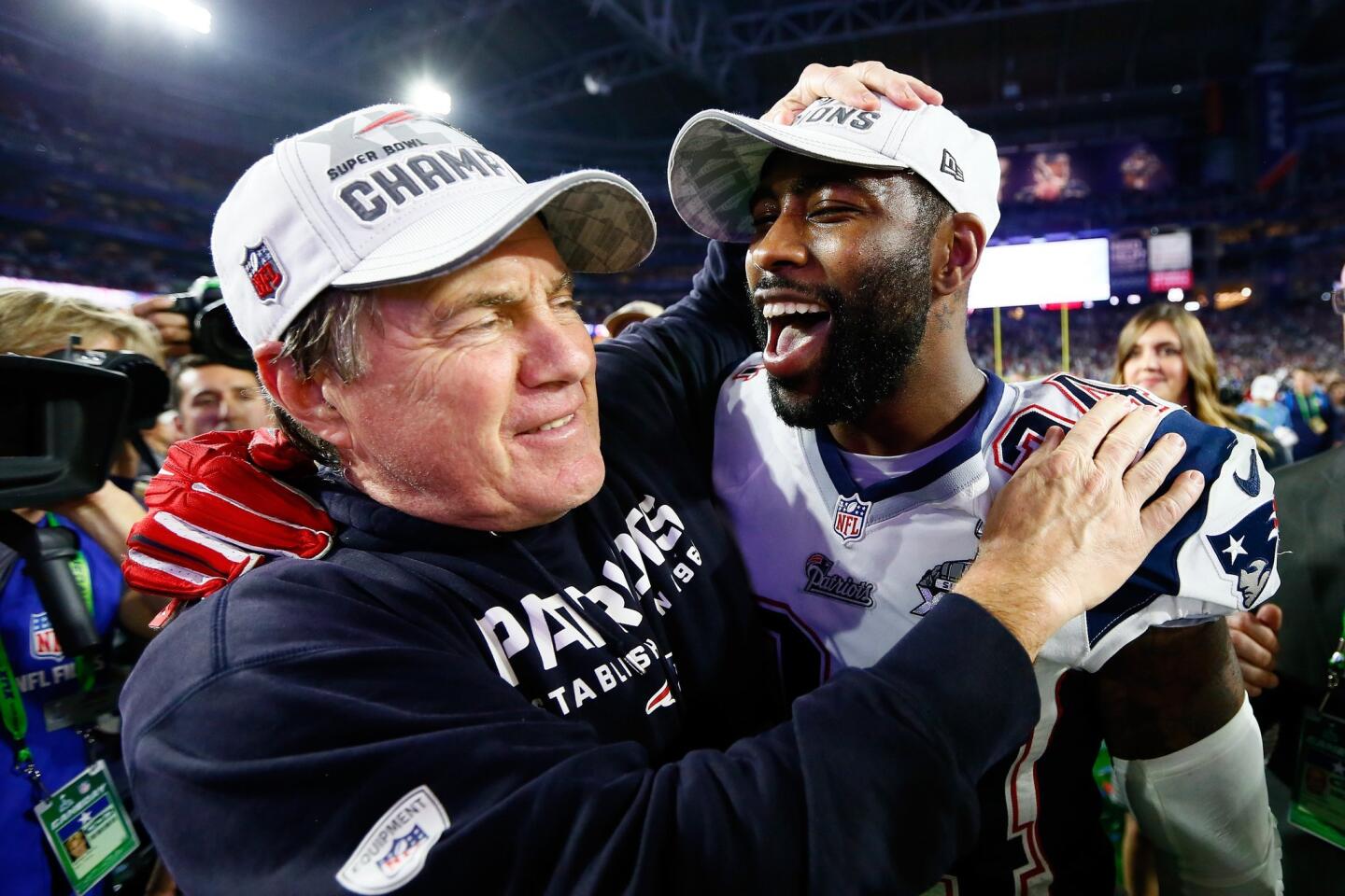 Patriots coach Bill Belichick celebrates with Darrelle Revis after the win.