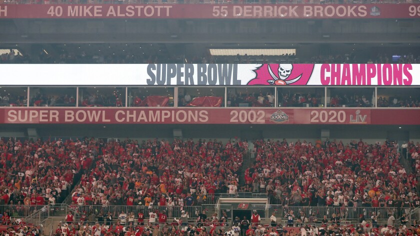 The Tampa Bay Buccaneers uncover their 2020 Super Bowl banner before an NFL football game against the Dallas Cowboys Thursday, Sept. 9, 2021, in Tampa, Fla. (AP Photo/Mark LoMoglio)