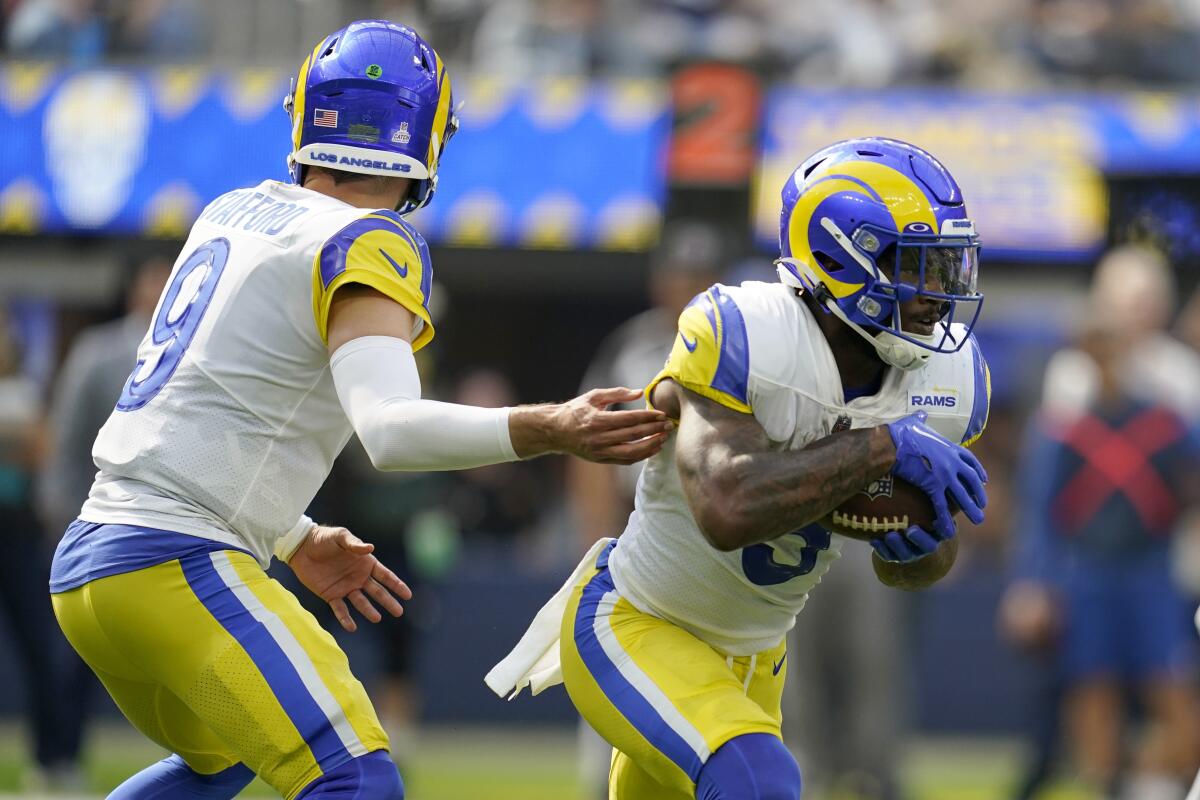  Rams quarterback Matthew Stafford hands the ball off to running back Cam Akers (3) against the Dallas Cowboys.