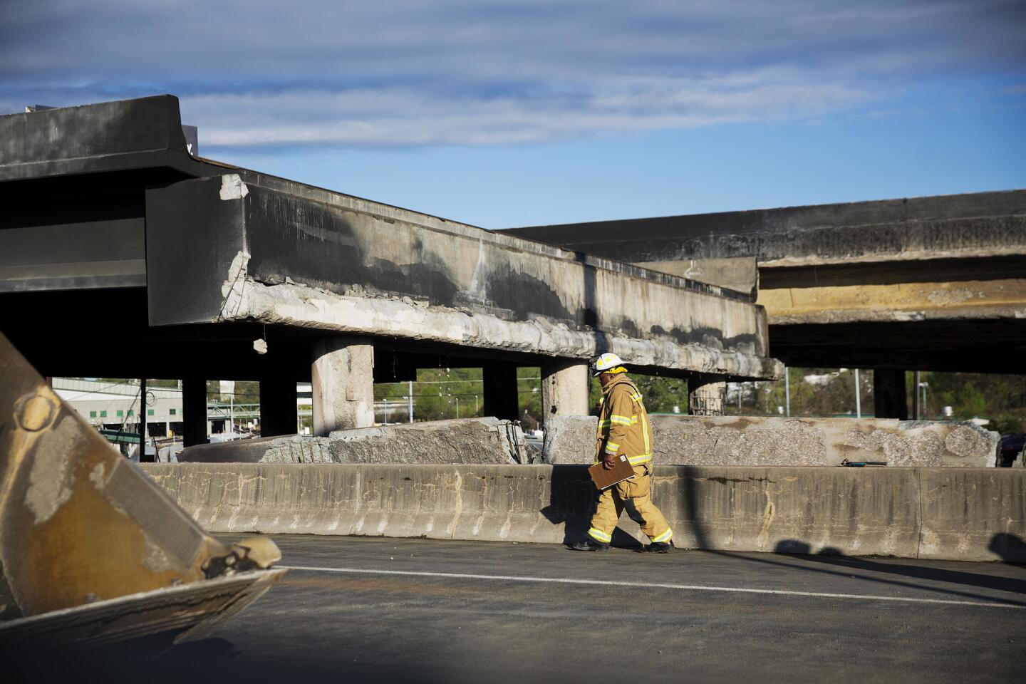 A firefighter checks out the collapsed I-85 overpass in Atlanta.