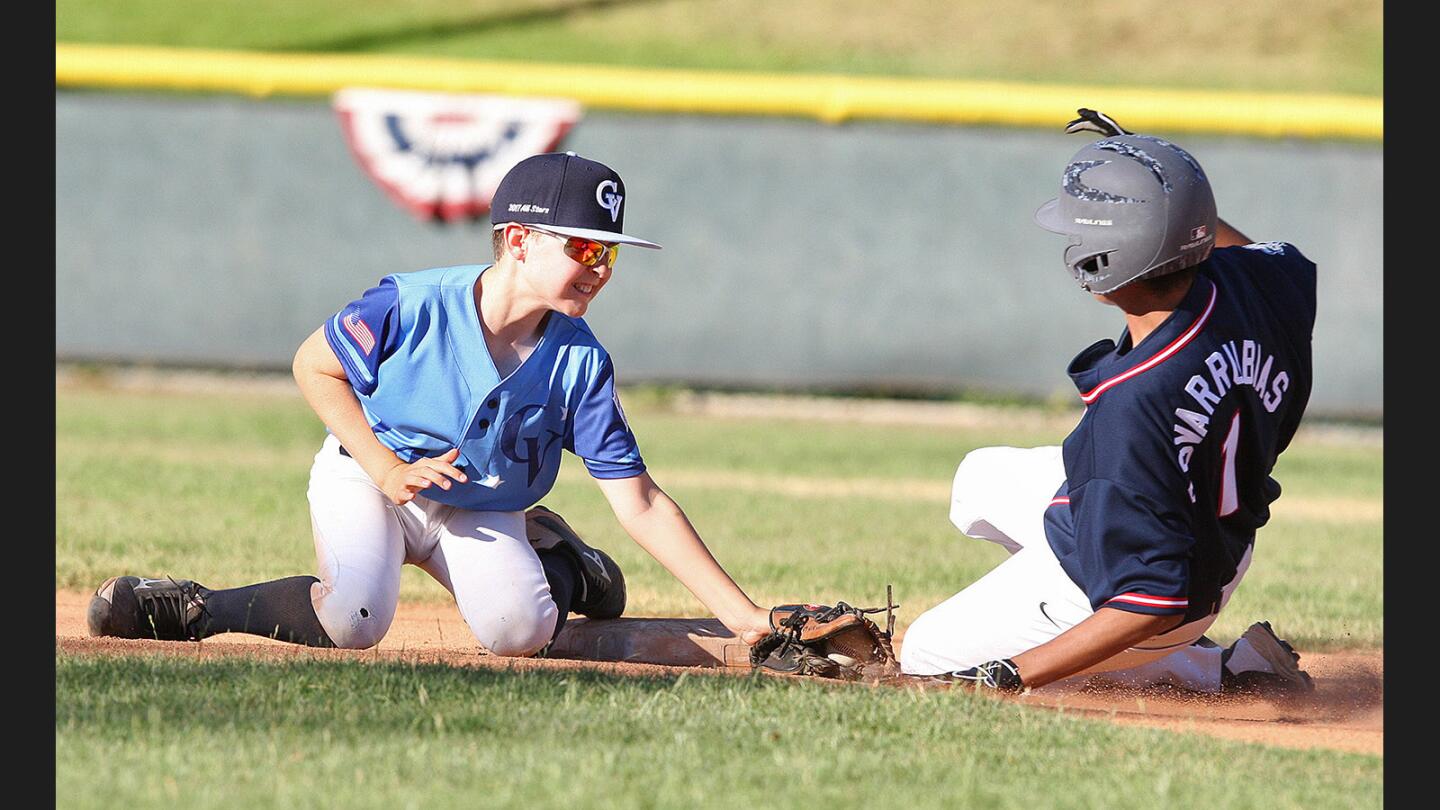 Crescenta Valley's Nicolo Terenzi turns and tags out Jewel City/Jewish War Veterans/Vaquero's AJ Covarrubias in a steal attempt at second base in a Little League Majors baseball game in the Tri-Cities District 16 Tournament at Montrose Park in Montrose on Tuesday, June 27, 2017.