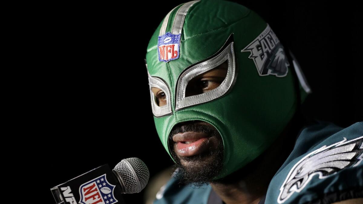 Philadelphia Eagles defensive tackle Fletcher Cox wears a wrestling mask as he takes part in a media availability for Super Bowl LII.