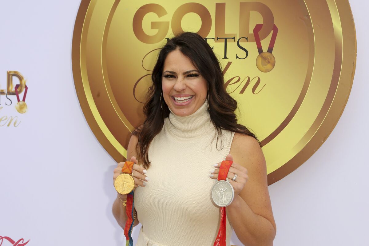 Jessica Mendoza shows off the Olympic medals she won competing on the U.S. softball team.