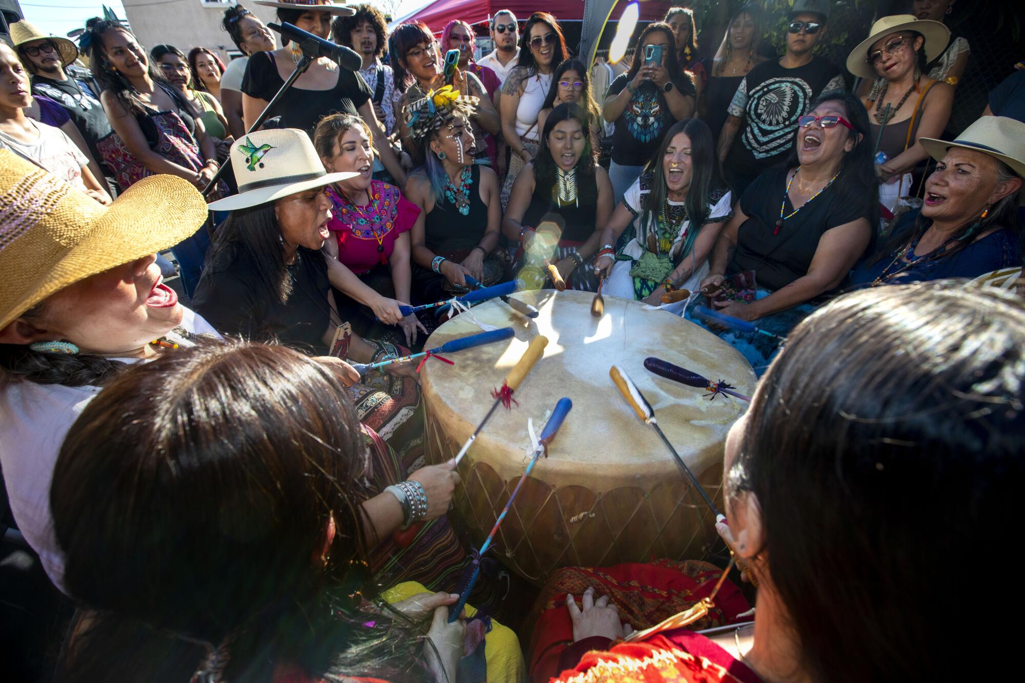 A women's healing collective performs a drum ceremony 