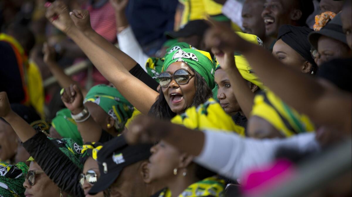 AFrican National Congress supporters cheer anti-apartheid fighter Winnie Madikizela-Mandela during her funeral Saturday.