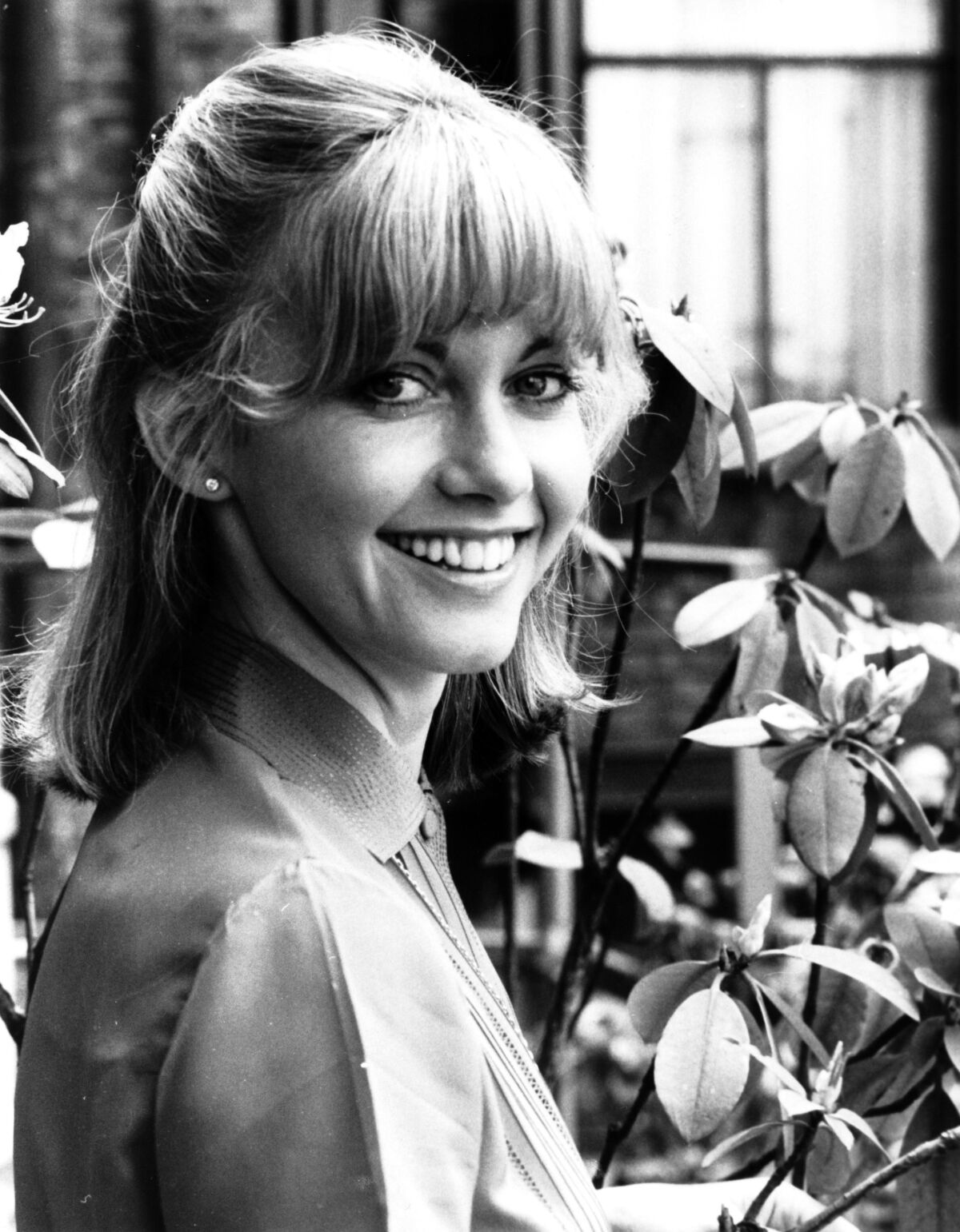 Olivia Newton-John in the 1970s, photographed outdoors.