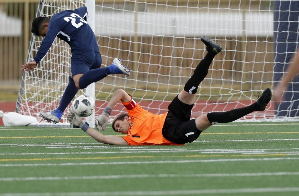 Marina goalkeeper Kyle Miller, bottom, protects the net against California’s Juan Lozano in a pool-play match of the 33rd annual Marina Holiday Classic on Dec. 26, 2019.
