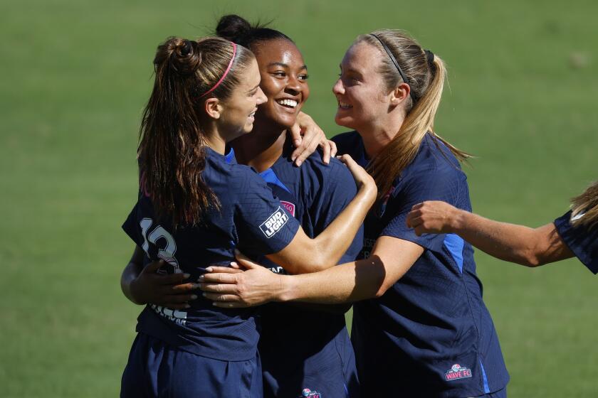 The San Diego Wave's Jaedyn Shaw celebrates with Alex Morgan, left, and Kyra Carusa.