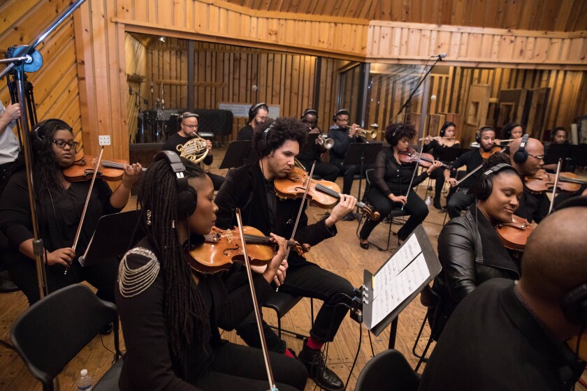 Black classical musicians perform in a recording studio.