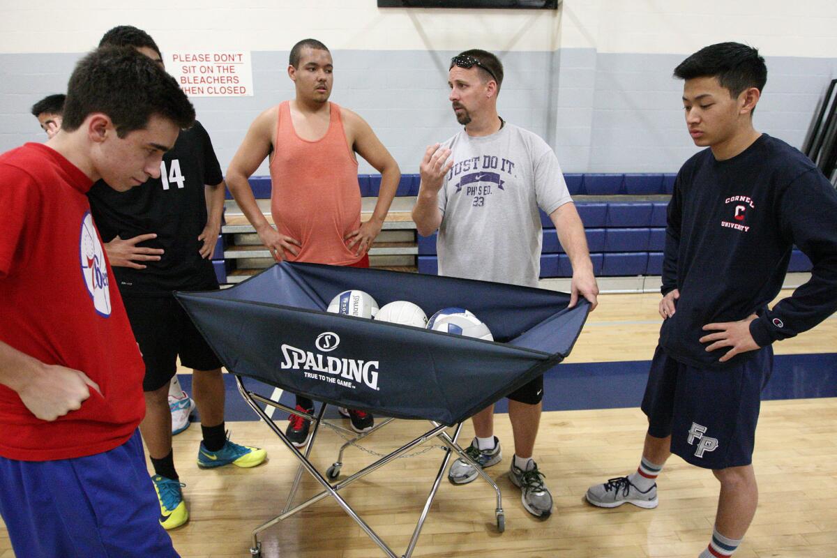 Flintridge Prep boys' volleyball coach Sean Beattie talks to his team during practice on Tuesday, February 25, 2014.