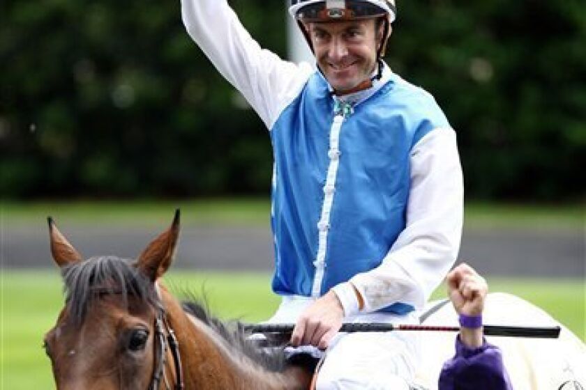 Olivier Peslier celebrates his victory on Goldikova in The Queen Anne Stakes on day one of the Royal Ascot Meeting at Ascot Racecourse, Ascot England Tuesday June 15, 2010. (AP Photo/David Davies/PA)